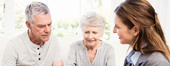 elderly couple having a conversation with clinician