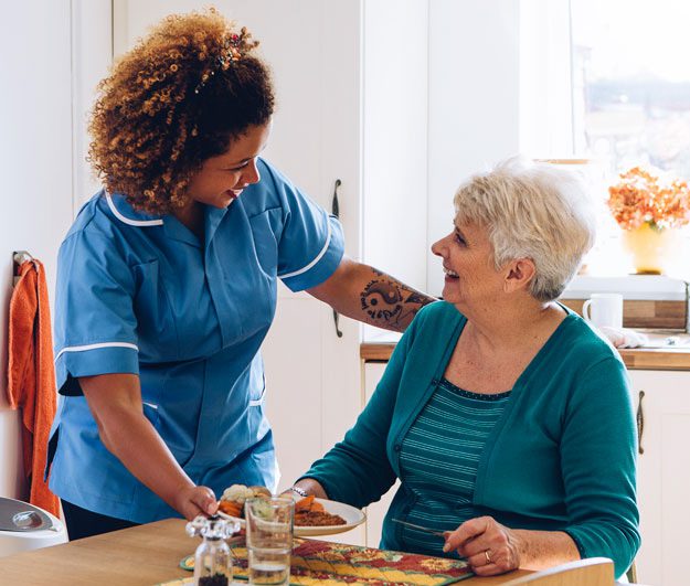 A senior enjoys a meal in assisted living.