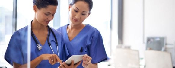 nurses using a tablet