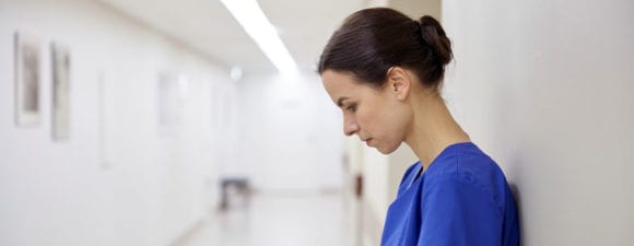 nurse reflecting in hallway