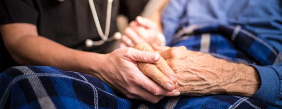 hospice caregiver holding hands