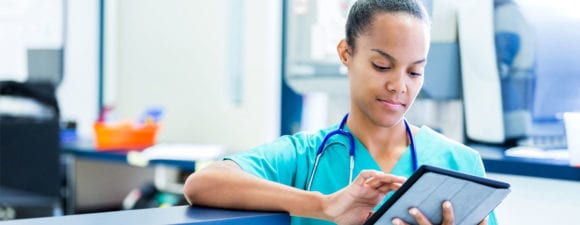 millennial nurse using tablet
