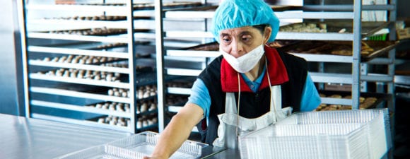 woman with developmental disability working in bakery