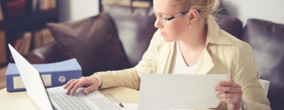 woman working on desk with laptop