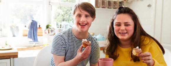 teens celebrating birthday with cupcakes