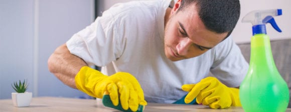 man scrubbing table as a party of a job for people with intellectual and developmental disabilities