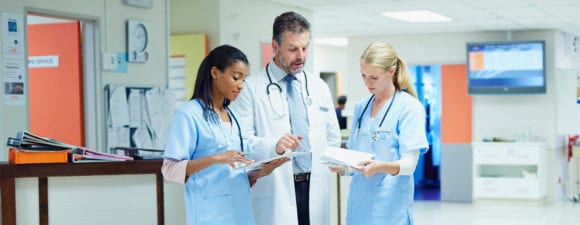 doctors talking with nurses in hospital