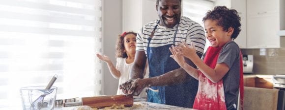 family baking together in kitchen