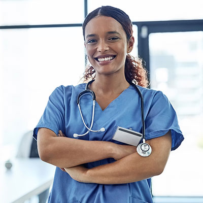 Smiling, satisfied nurse wearing scrubs