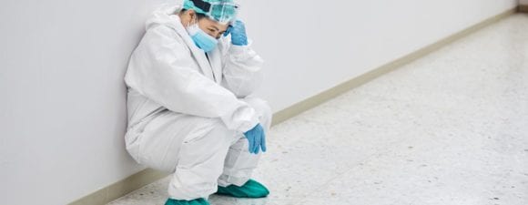 A female healthcare worker looking despondent