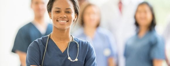 Young nurse standing in front of other nurses