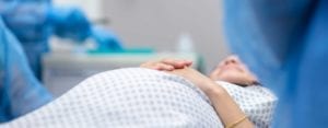 patient prepares for C-section in OR.
