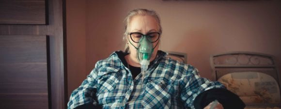 senior woman with breathing mask