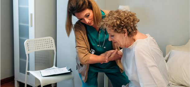 caregiver helps an elderly patient