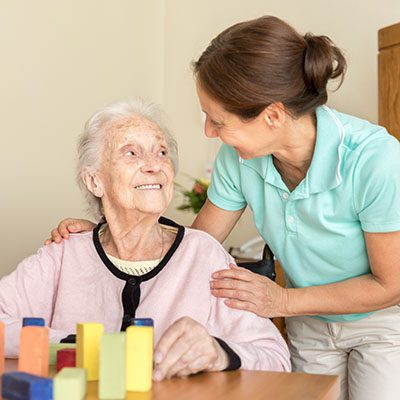 Dementia – Home Caregiver Communicates With Senior Adult Woman