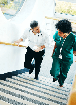 clinicians walking upstairs in a hospital