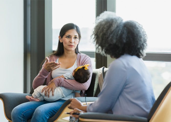 A counselor working with a new mother experiencing birth trauma
