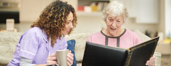 Dementia care nurse communicates with senior woman