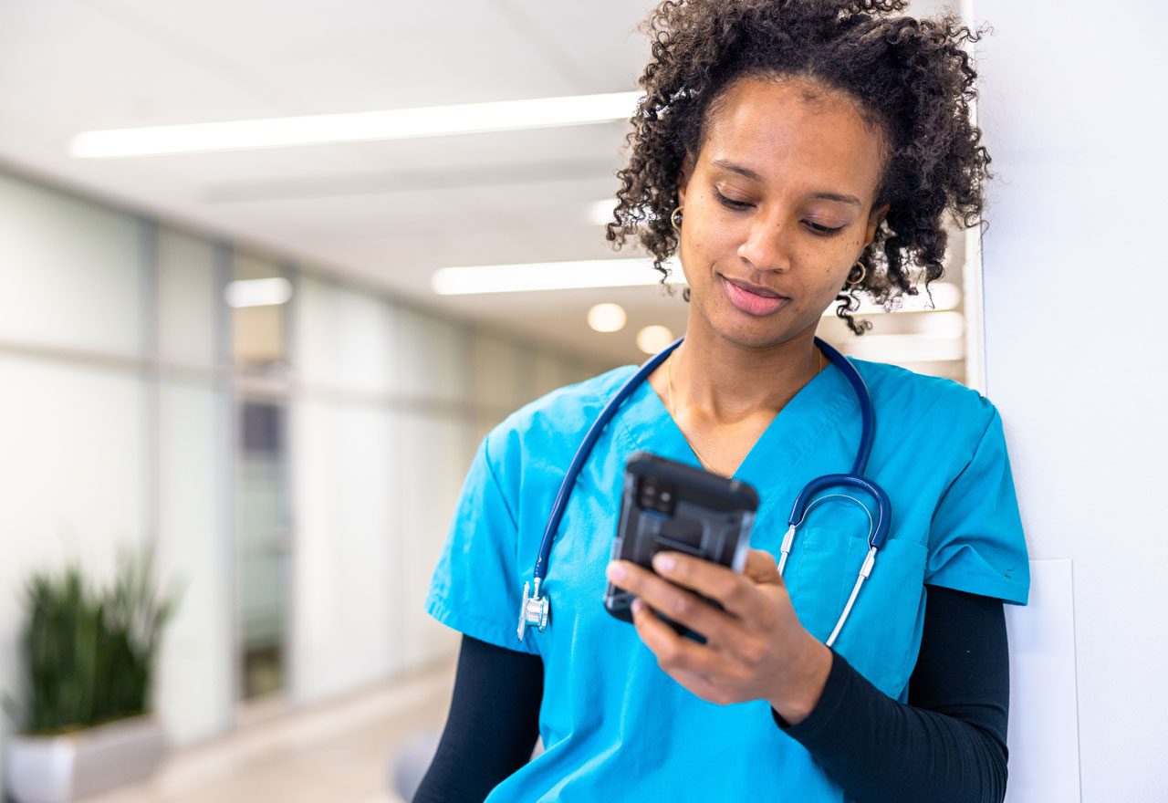 nurse examines mobile device
