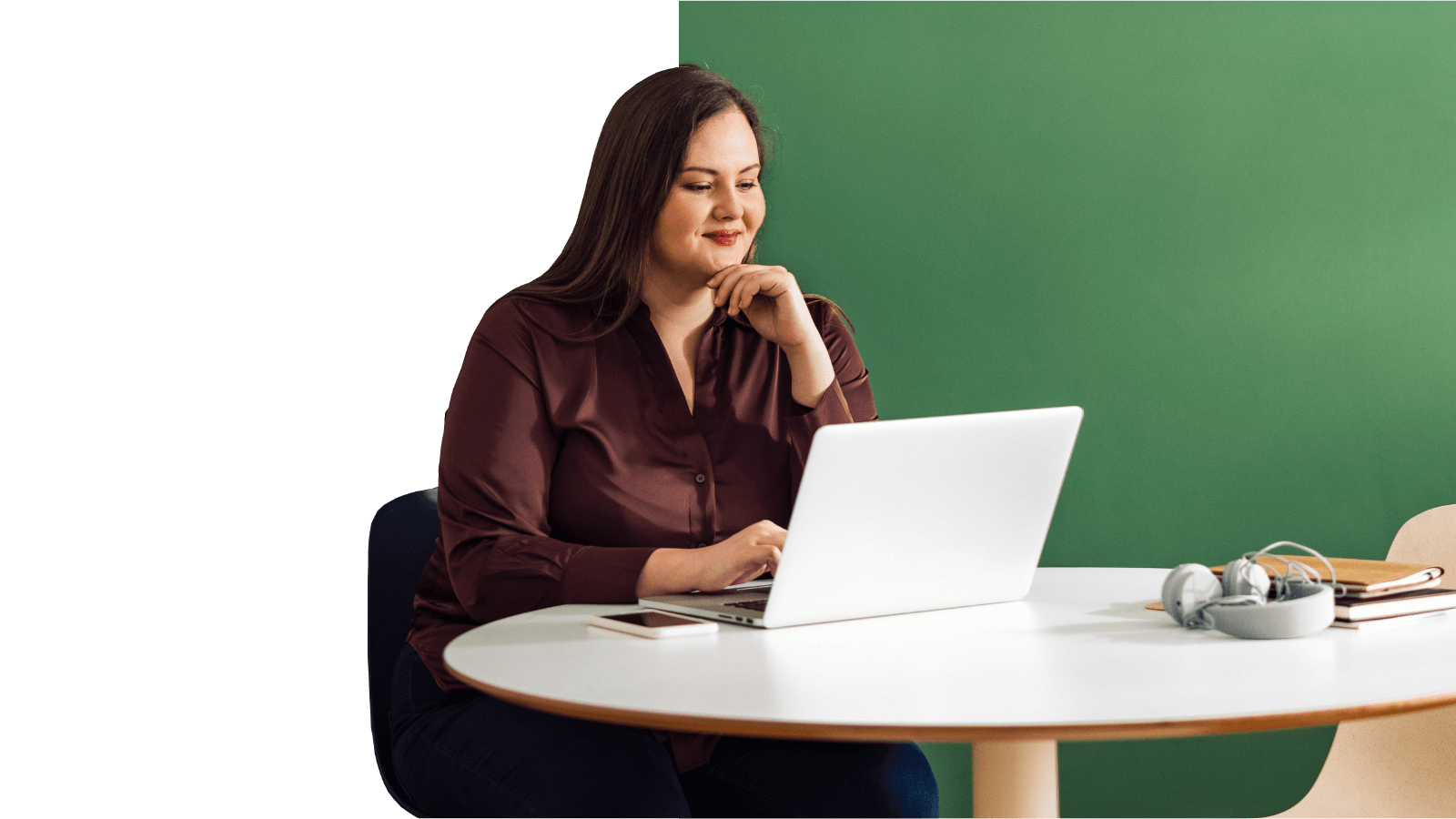 woman works at a circular table on a laptop