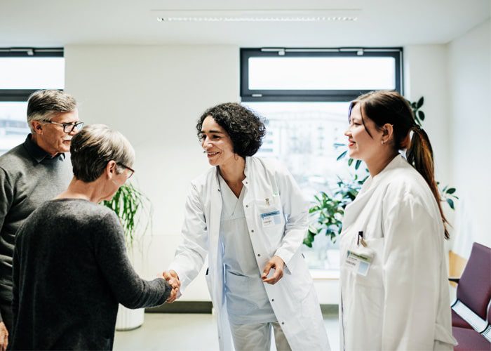 Two female healthcare professionals discussing whole person care with patients