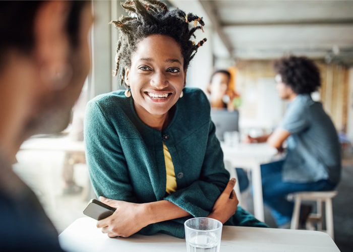 A woman discussing building organizational resilience with a coworker