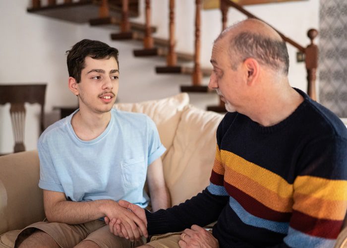 A man teaching a teenager with IDD about self-advocacy
