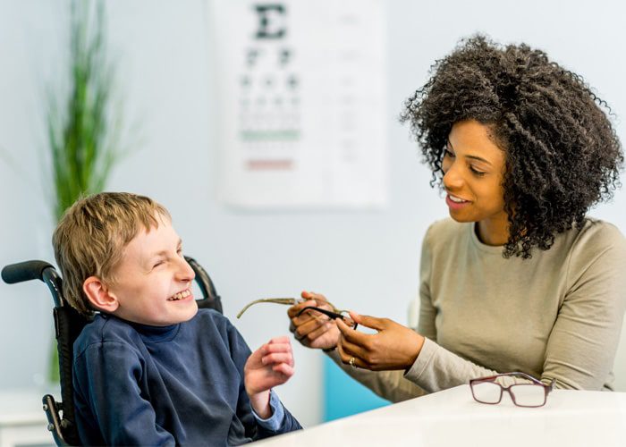 A woman supporting an adolescent boy with learning self-advocacy skills