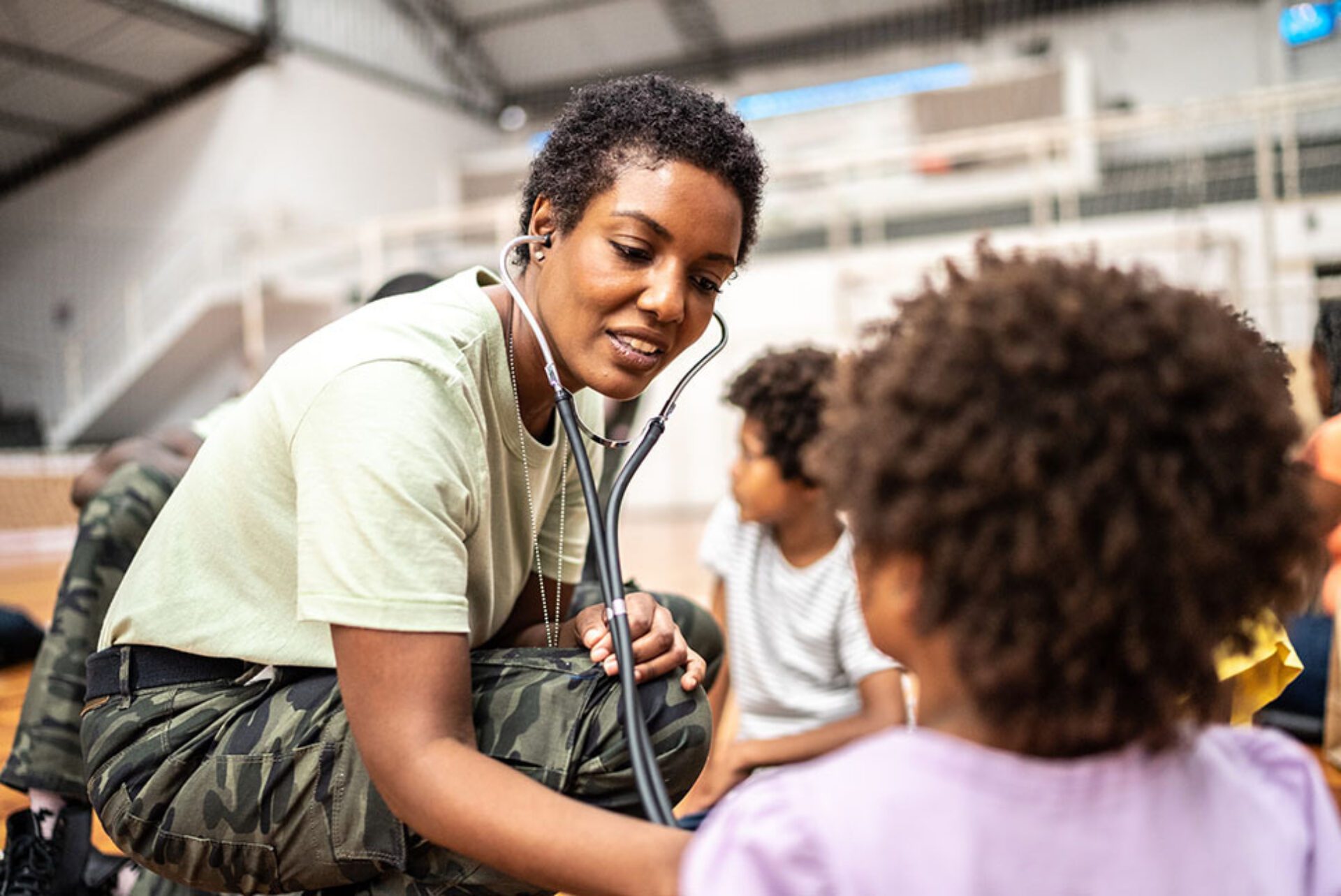 A physician examines a young patient during an emergency