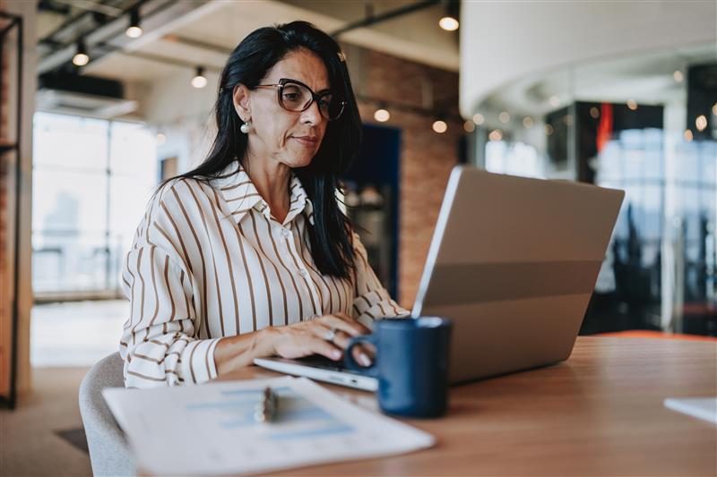 Woman in an office working on a laptop